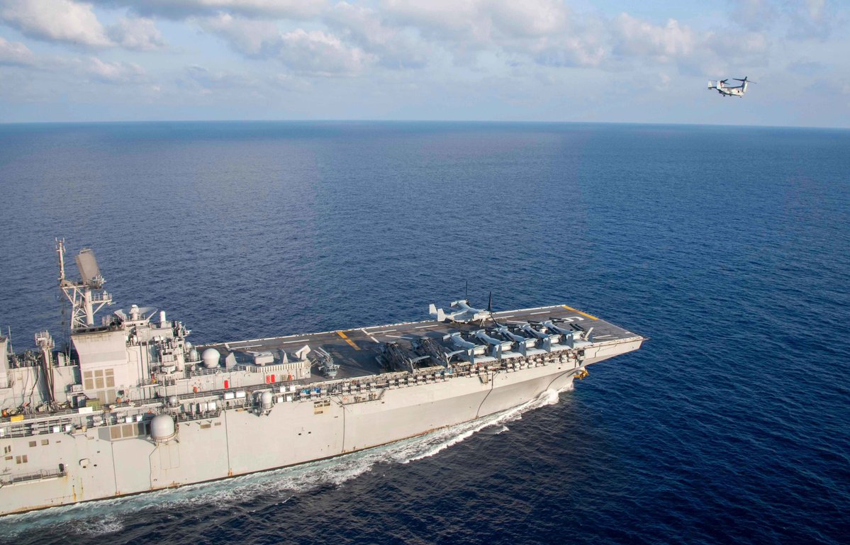 Assault ship USS AMERICA LHA6 cruising the South China Sea 18 April. USMC Marine Corps MV-22B Osprey tilt-rotor aircraft and CH-53E helicopters are ranged forward, with F-35B Joint Strike Fighters aft