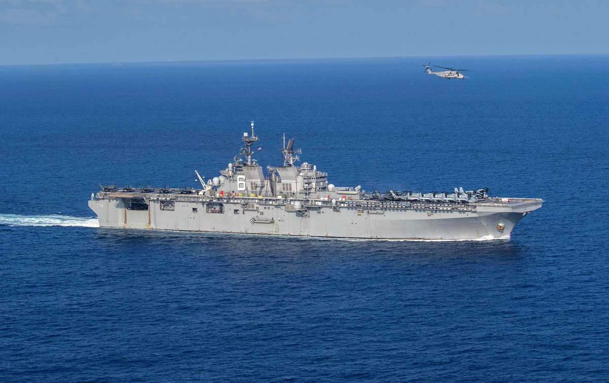 Assault ship USS AMERICA LHA6 cruising the South China Sea 18 April. USMC Marine Corps MV-22B Osprey tilt-rotor aircraft and CH-53E helicopters are ranged forward, with F-35B Joint Strike Fighters aft