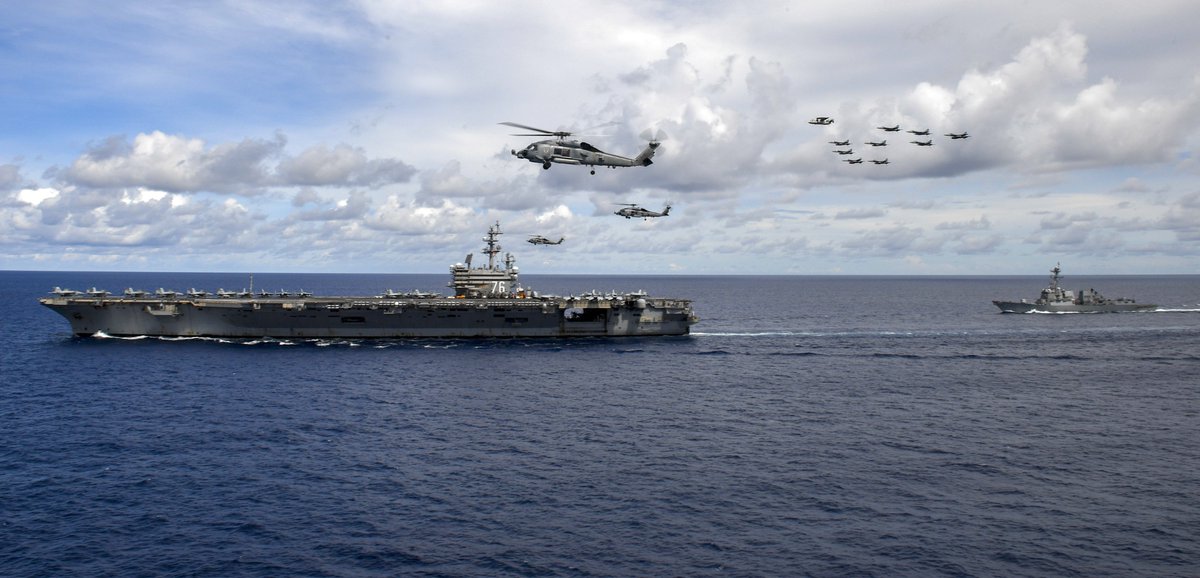 Carriers NIMITZ CVN68 and RONALD REAGAN CVN76 posed for a photo exercise 6 July in the South China Sea after a few days of operating in concert. Carrier Air Wings 5 fm REAGAN and 17 fm NIMITZ flew overhead while destroyers & cruisers flanked the flattops strategicmessaging