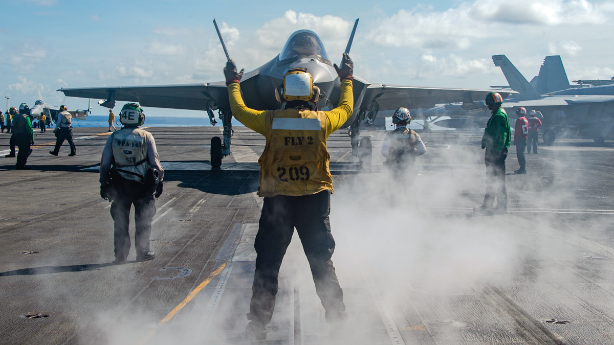 USNavy Sailors manage the flight deck aboard aircraft carrier USSCarlVinson during operations this week in the South China Sea