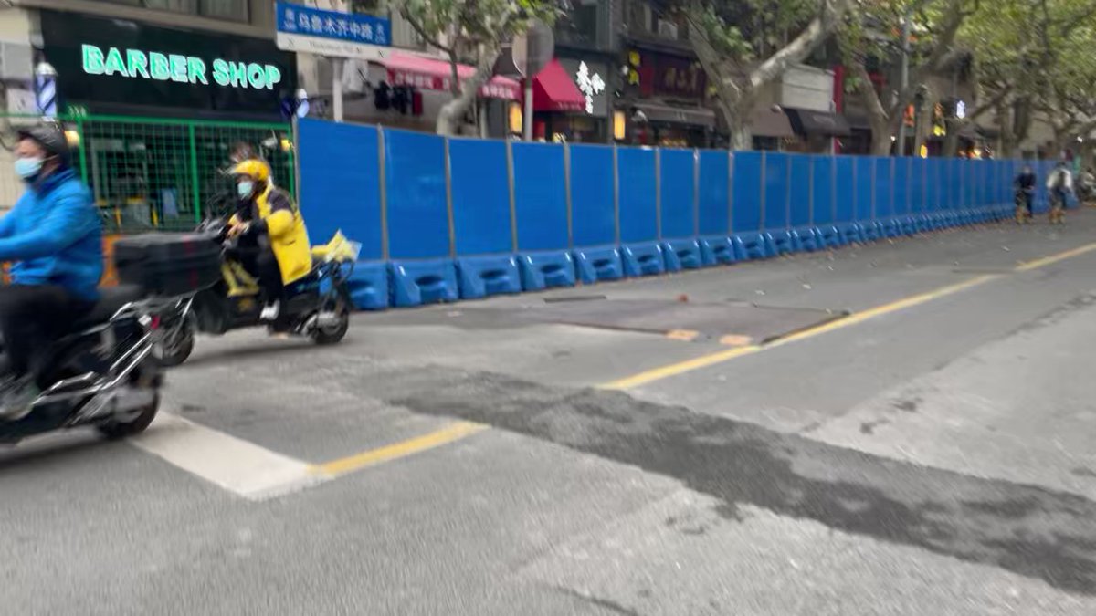 Wulumuqi Road, the sight of protests and clashes over the past few days, now fenced up. Heavy police and security presence. People who take photos are being stopped by police and forced to delete. Two people taken away for refusing to